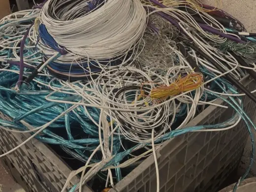 Stillage cage packed with coiled white and blue cable
