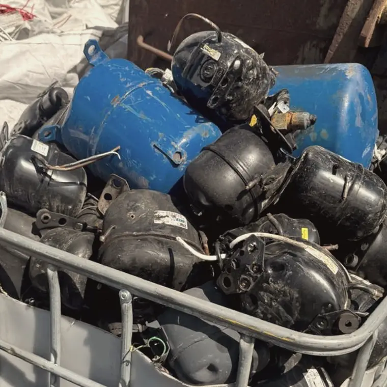 Stillage cage filled with scrap refrigeration compressor pots and receiver tanks