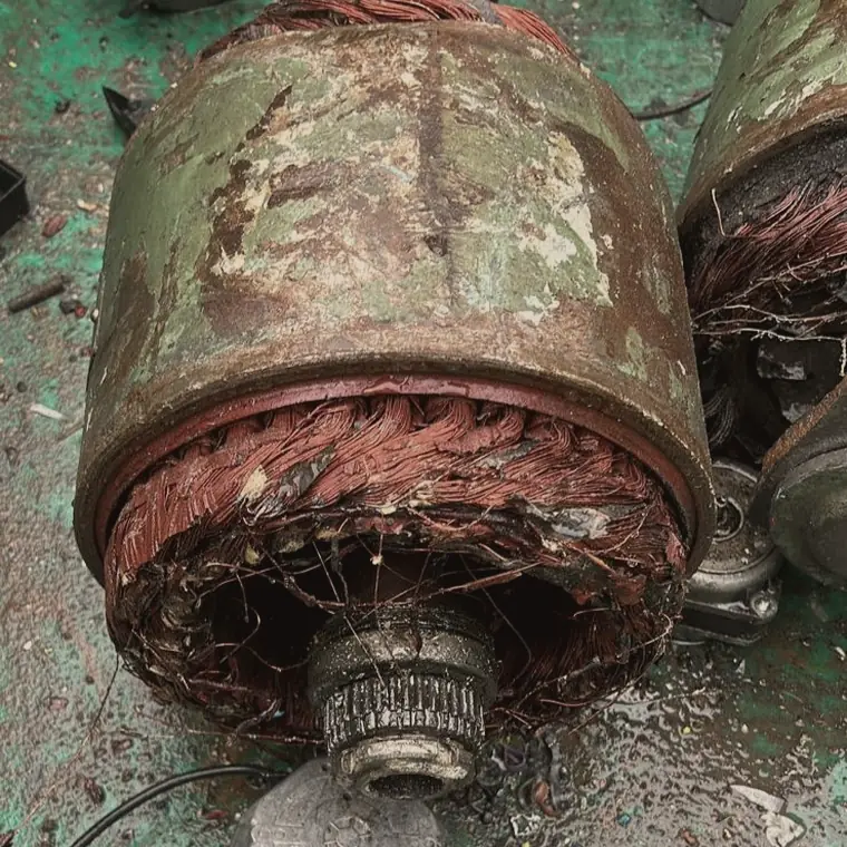 Scrap electric motor cut open, showing the copper windings inside the casing